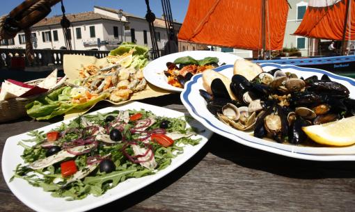 Fresh seafood dishes in a picturesque maritime setting.